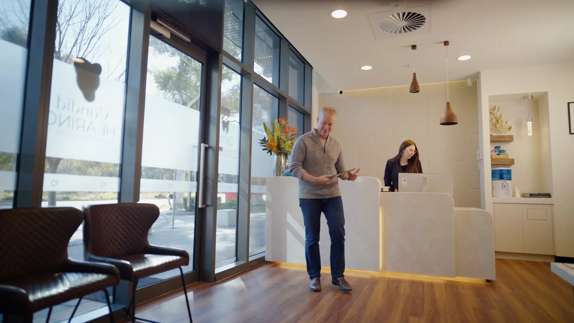 A patient arriving at the Dental Embassy reception desk in Braddon