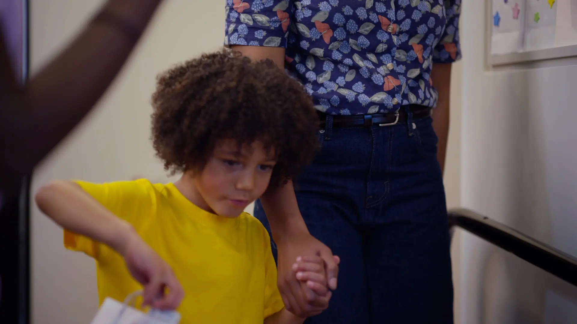 A child holding a parent's hand at the dental practice