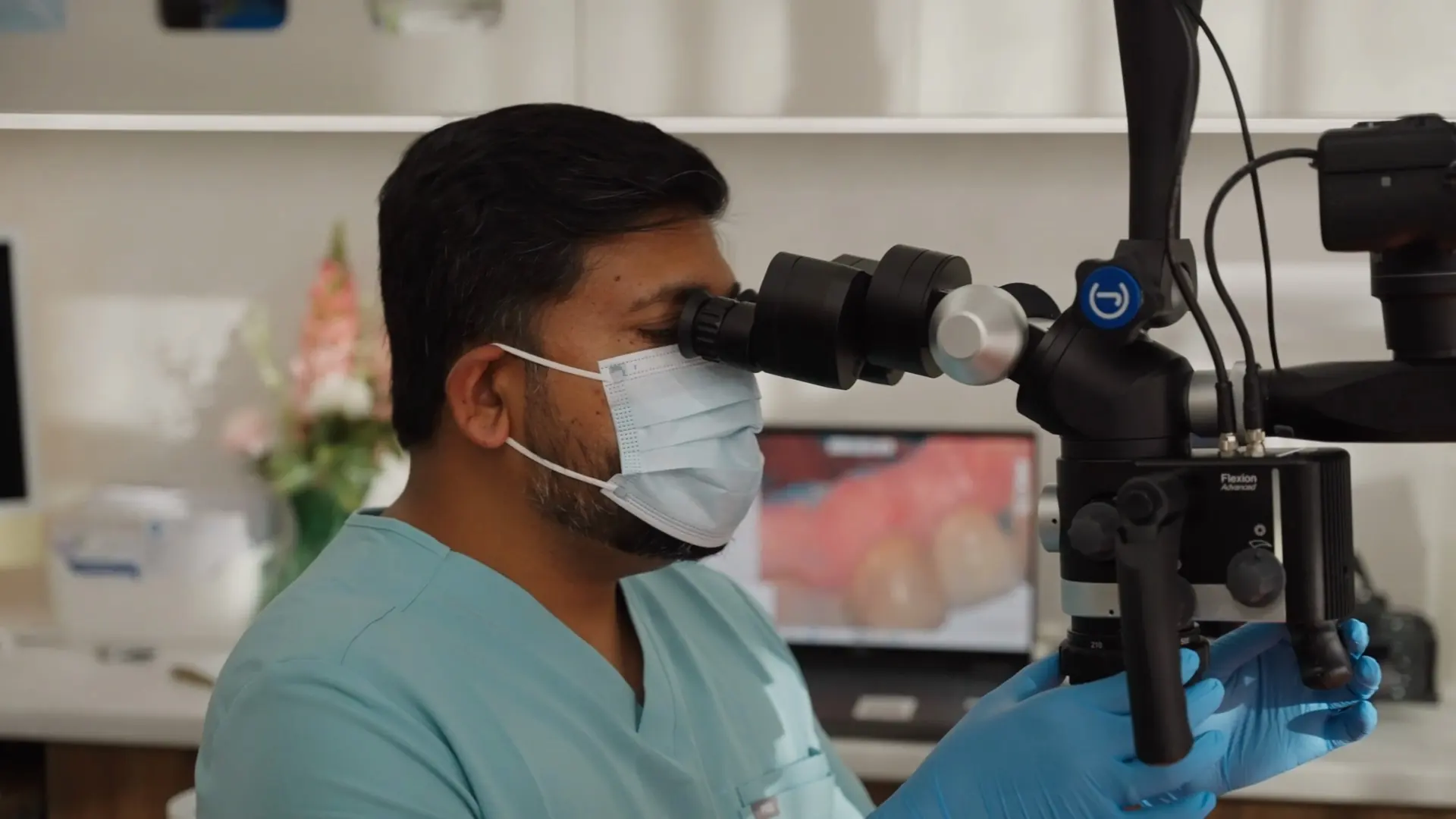 A dentist looking through the dental microscope