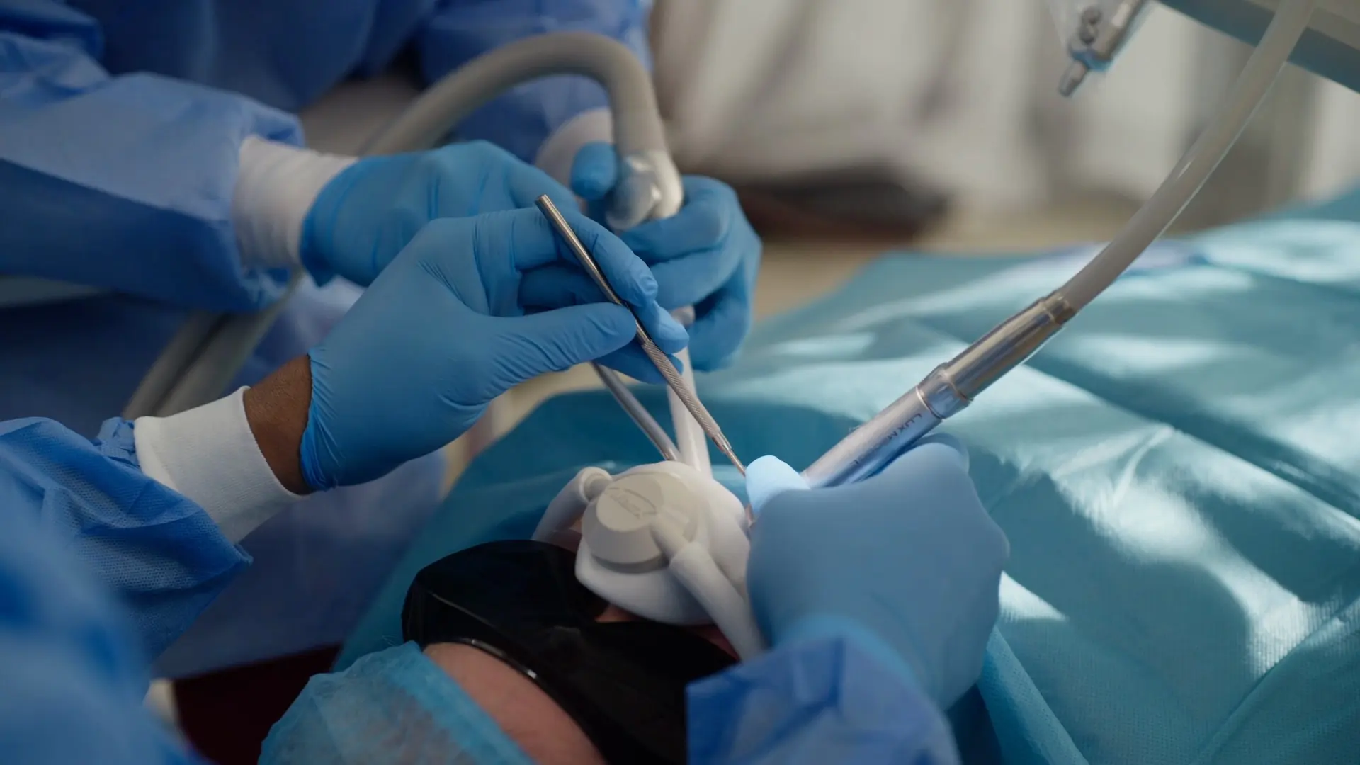 Gloved hands working during a surgical procedure