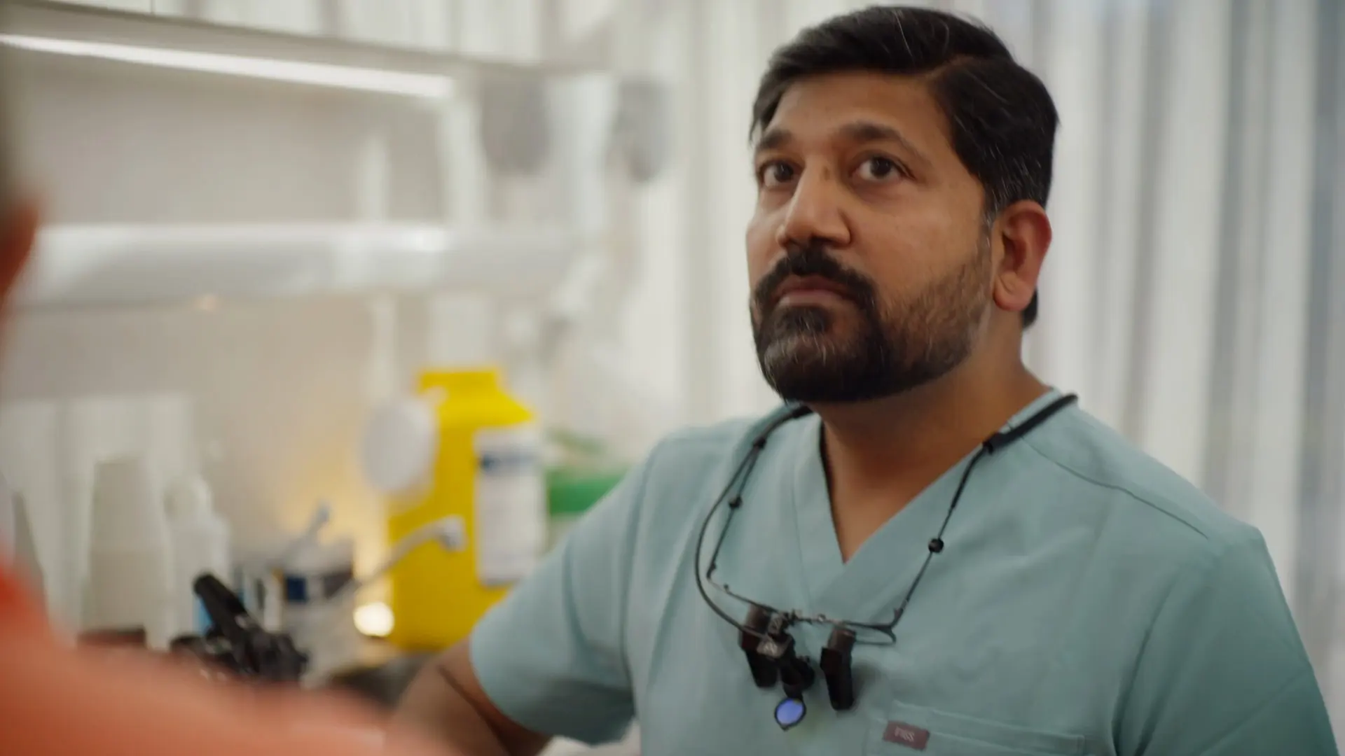 Dr Sri listening to a patient